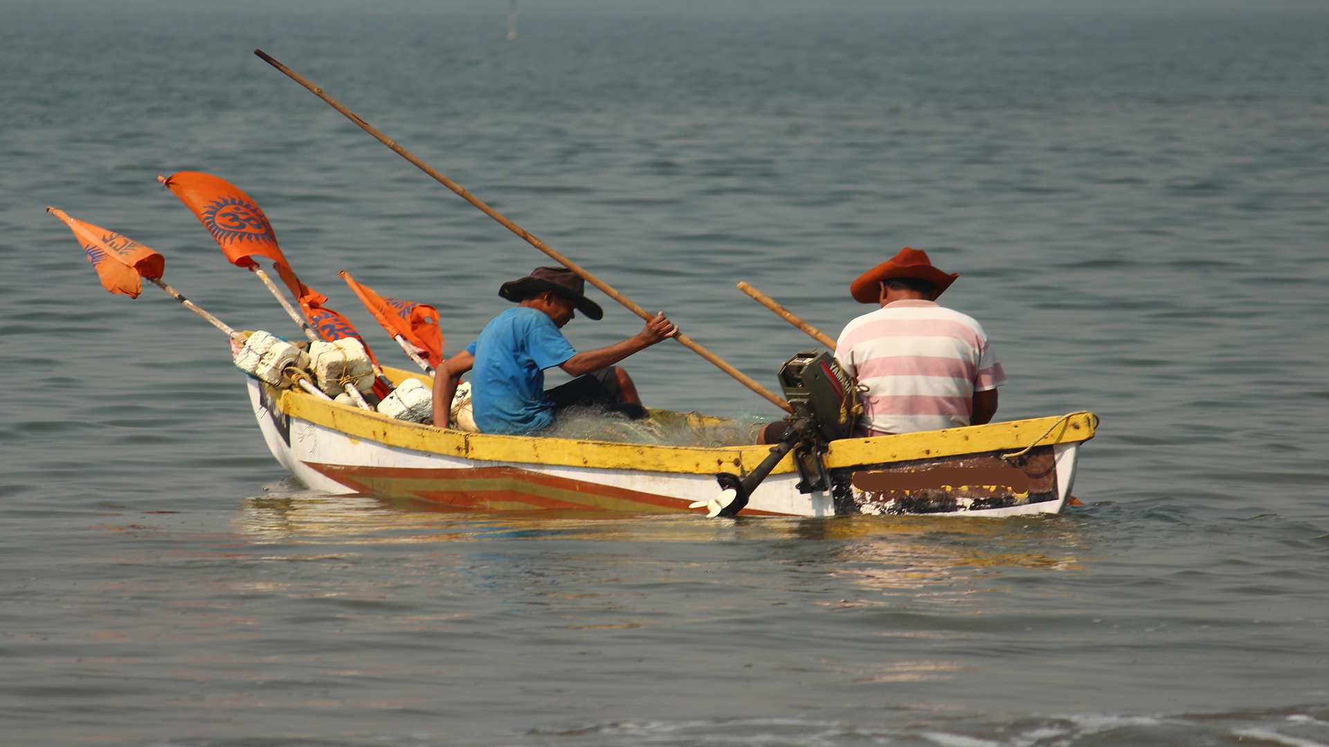 two fishermen in one boat fishing to survive and feed their families